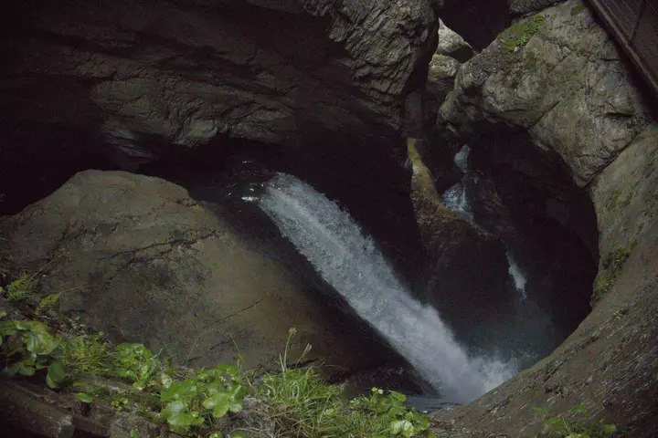 A picture of a waterfall of the Trümmelbach Falls in a cave.